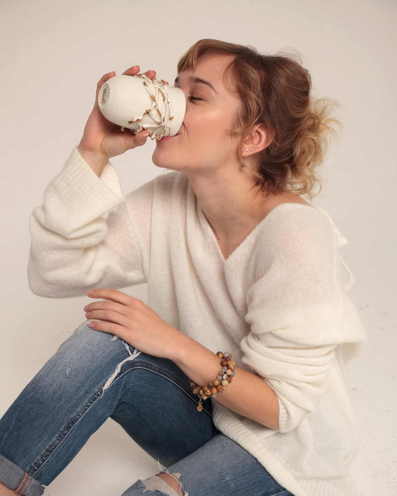 girl drinking from a cup