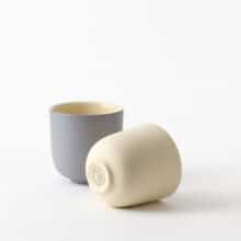 espresso-pair-blueberry-yellow-side two minimal espresso cups, one lies on a side