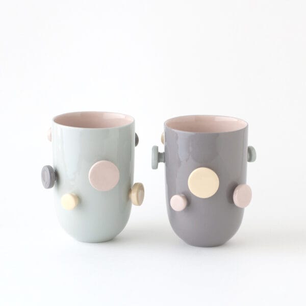 colorful mugs with round knobs