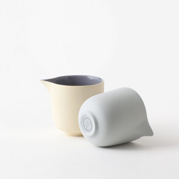 minimal-creamer-pair-yellow-blue-blueberry-side two small creamers, one lies on its side