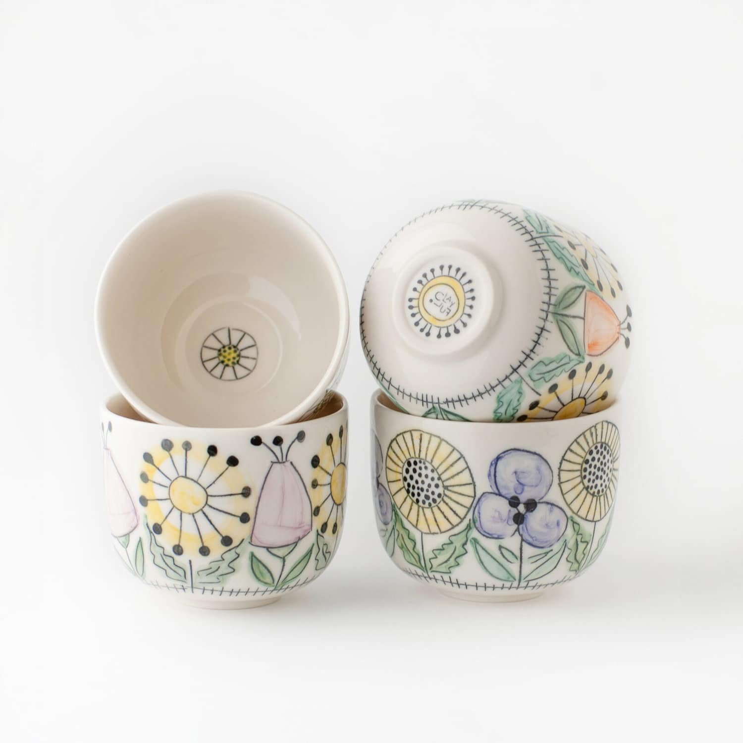 a set of cups with flowers