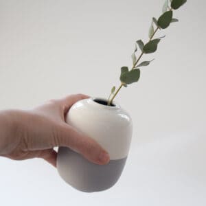 small ceramic vase in hand